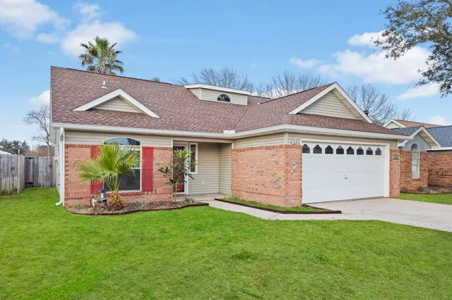 a front view of house with a garden