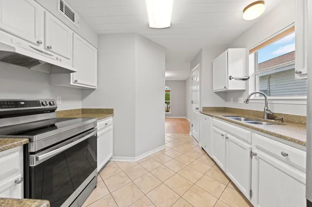 a kitchen with stainless steel appliances a refrigerator and a stove top oven
