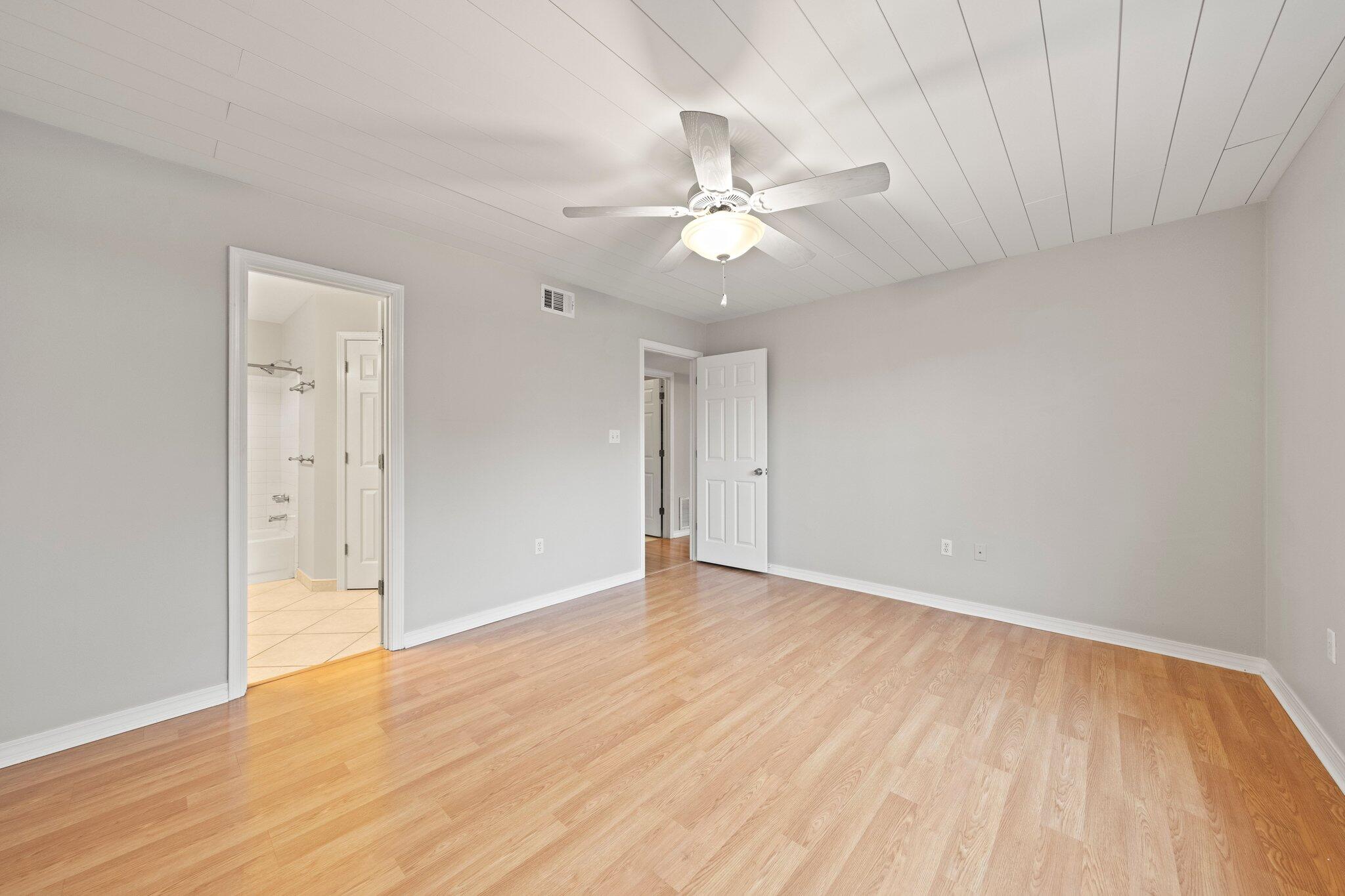3621 Goldsbys Way Destin, FL 32541 - Photo 22 of 43 an empty room with wooden floor fan and windows