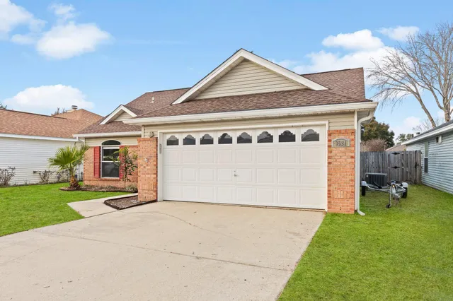 a view of a house with a yard and garage