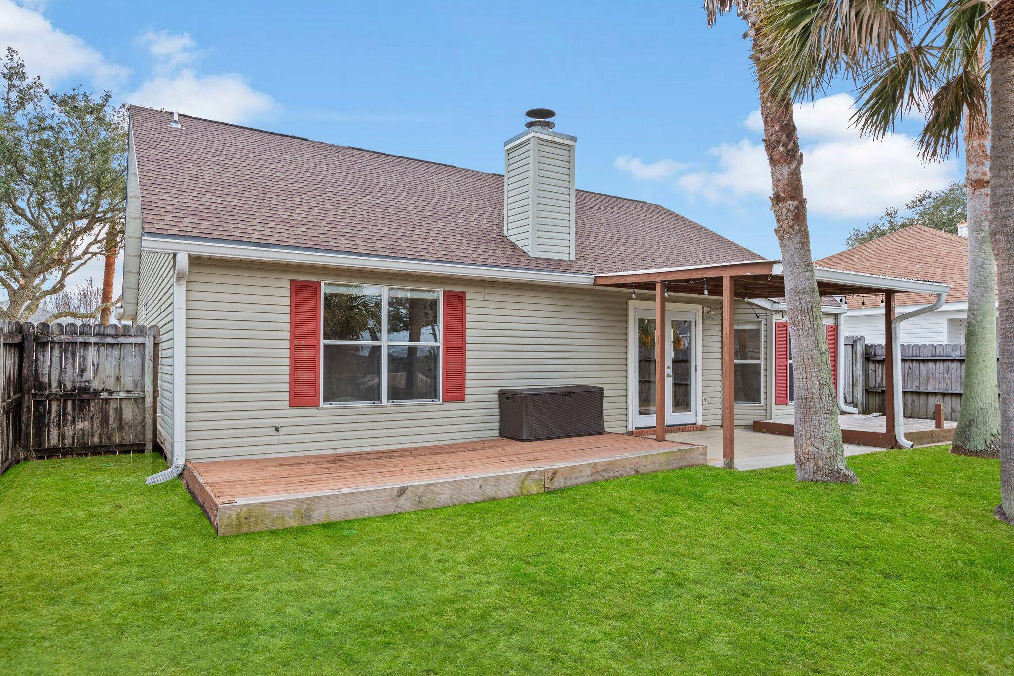 3621 Goldsbys Way Destin, FL 32541 - Photo 35 of 43 a front view of a house with a garden and yard
