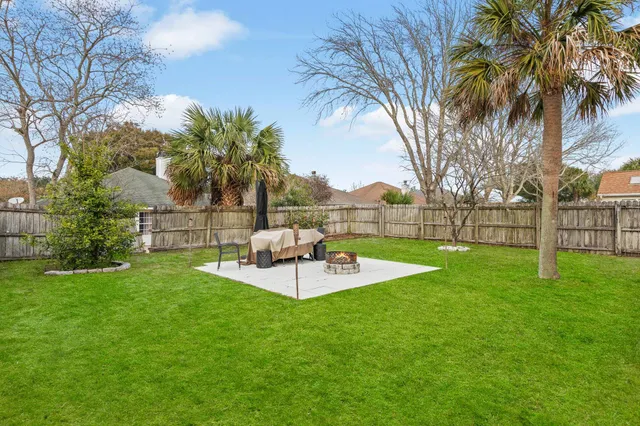 a view of a backyard with a garden and entertaining space