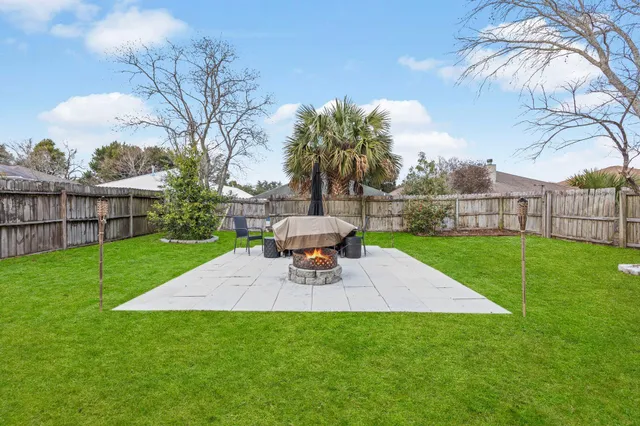 a view of a backyard with a garden and trees