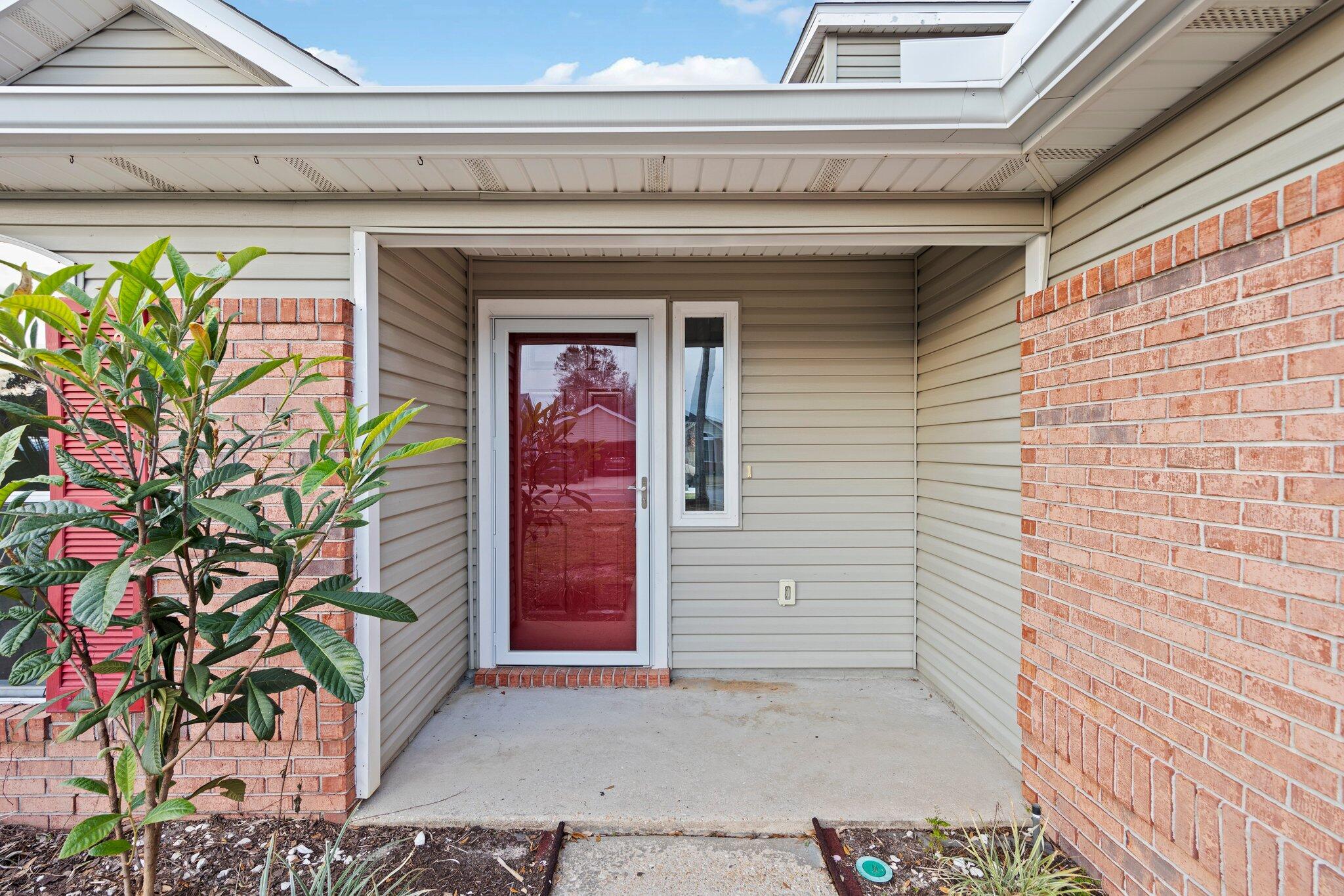 3621 Goldsbys Way Destin, FL 32541 - Photo 4 of 43 a potted plant in front of a door