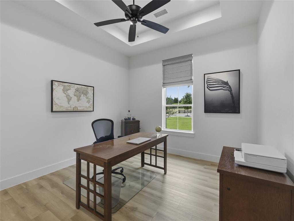 4211 Azalea Way Midlothian, TX 76065 - Photo 8 of 39 Second first level bedroom featuring wood-finish flooring, a tray ceiling with a ceiling fan, and a window with a fabric shade