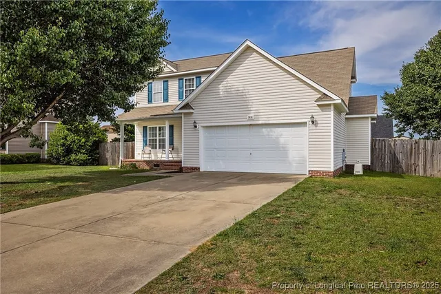 a view of backyard of house with garage