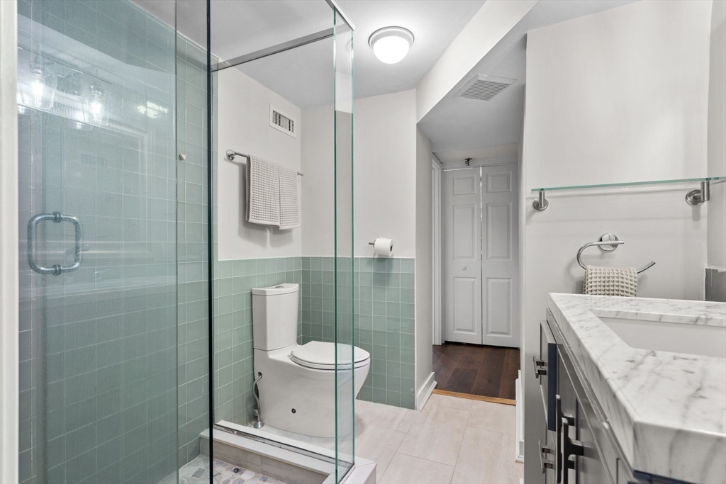 9 Appleton Street, Unit 102 Boston, MA 02116 - Photo 17 of 26 a bathroom with a sink a toilet and shower