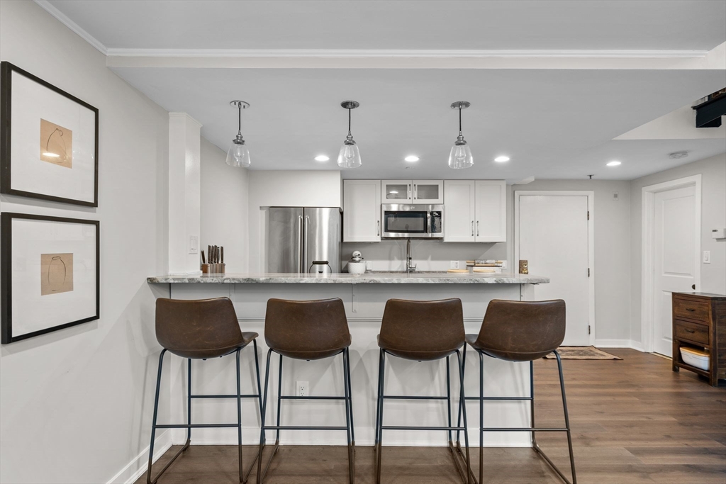 9 Appleton Street, Unit 102 Boston, MA 02116 - Photo 4 of 26 a kitchen with stainless steel appliances granite countertop a kitchen island a stove a cabinets a sink and a island