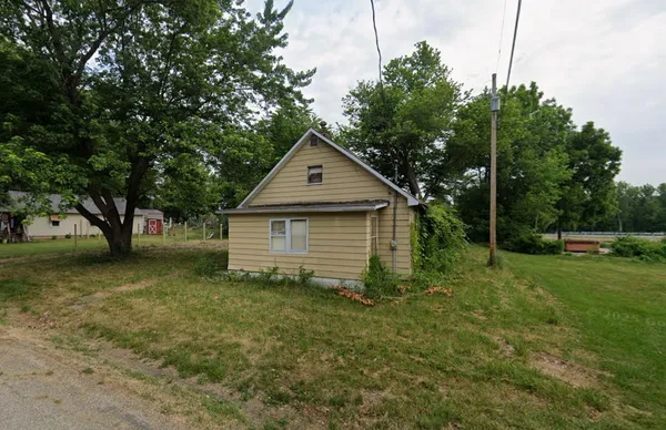 a front view of house with yard and trees
