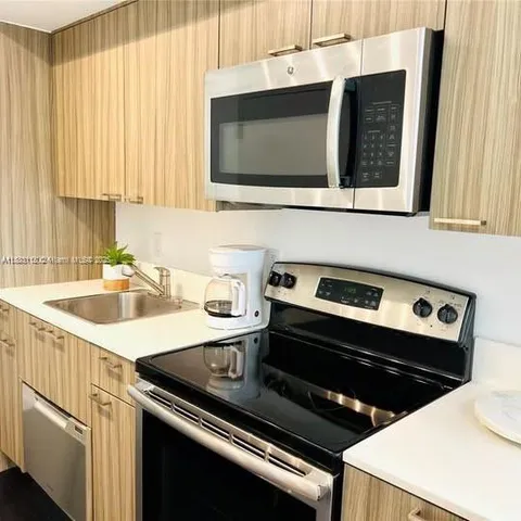 a kitchen with a stove and a microwave