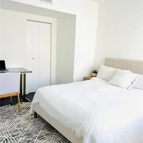 a bedroom with a bed and a table in it