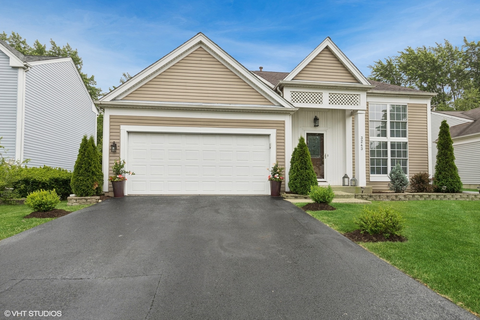 a front view of a house with a yard and garage