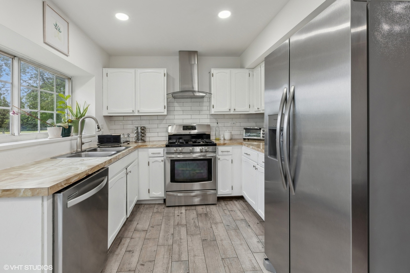 3243 Gresham Lane East Aurora, IL 60504 - Photo 8 of 28 a kitchen with a refrigerator sink and cabinets