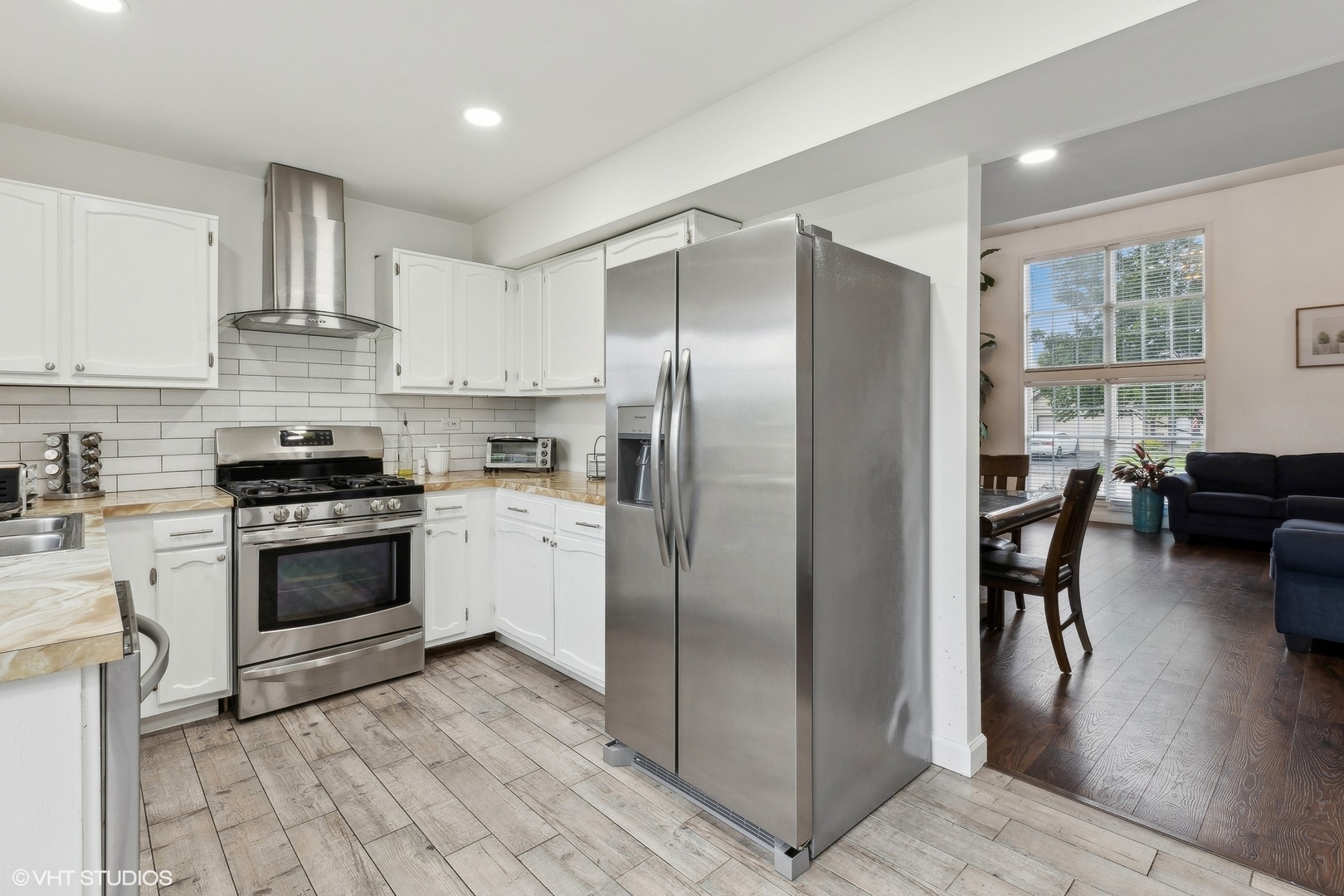 3243 Gresham Lane East Aurora, IL 60504 - Photo 9 of 28 a kitchen with stainless steel appliances granite countertop a stove refrigerator and a view of living room