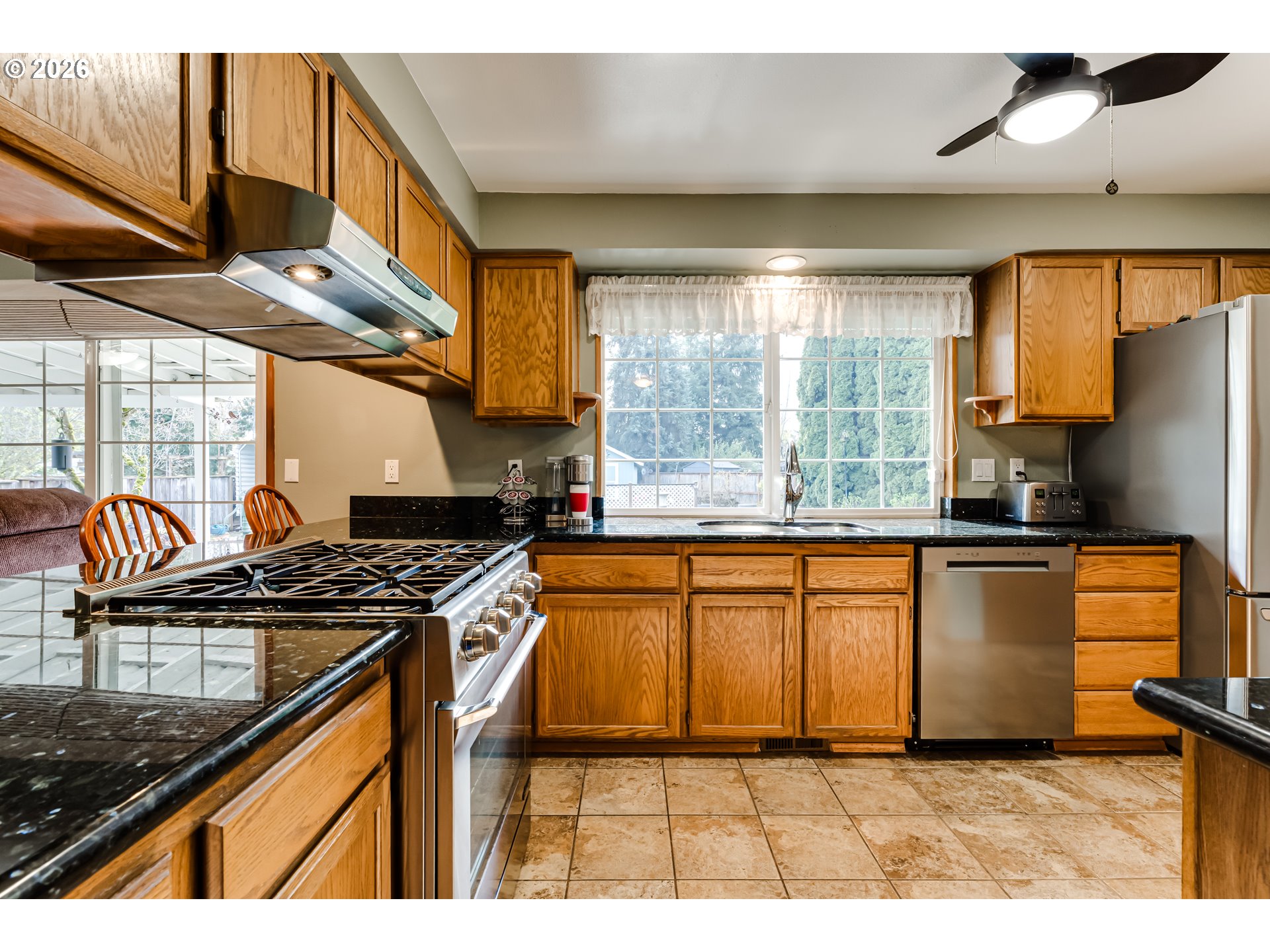 5131 Trevon Street Eugene, OR 97402 - Photo 13 of 42 a kitchen with stainless steel appliances granite countertop a stove a sink and a microwave