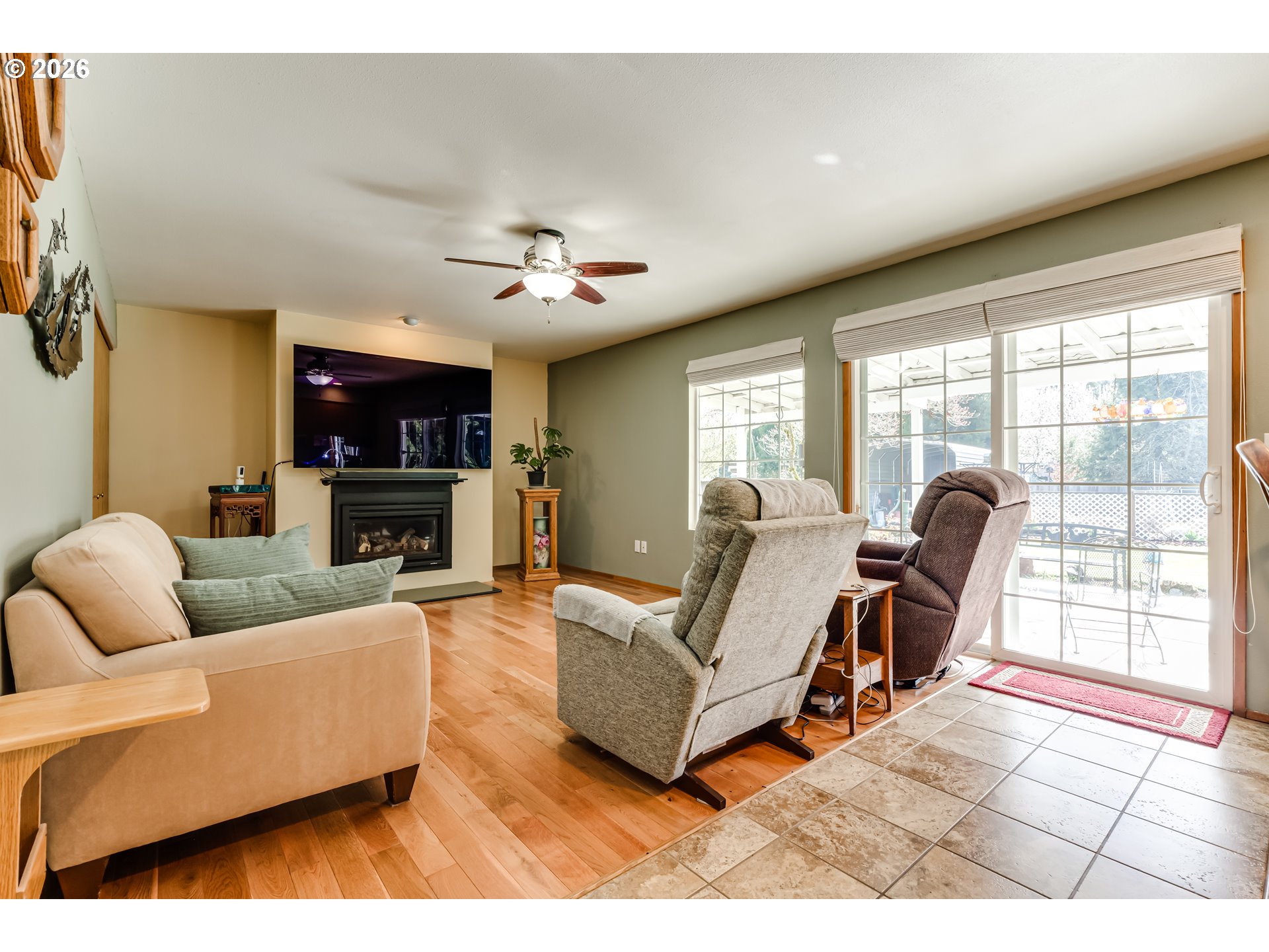 5131 Trevon Street Eugene, OR 97402 - Photo 16 of 42 a living room with furniture a flat screen tv and a large window