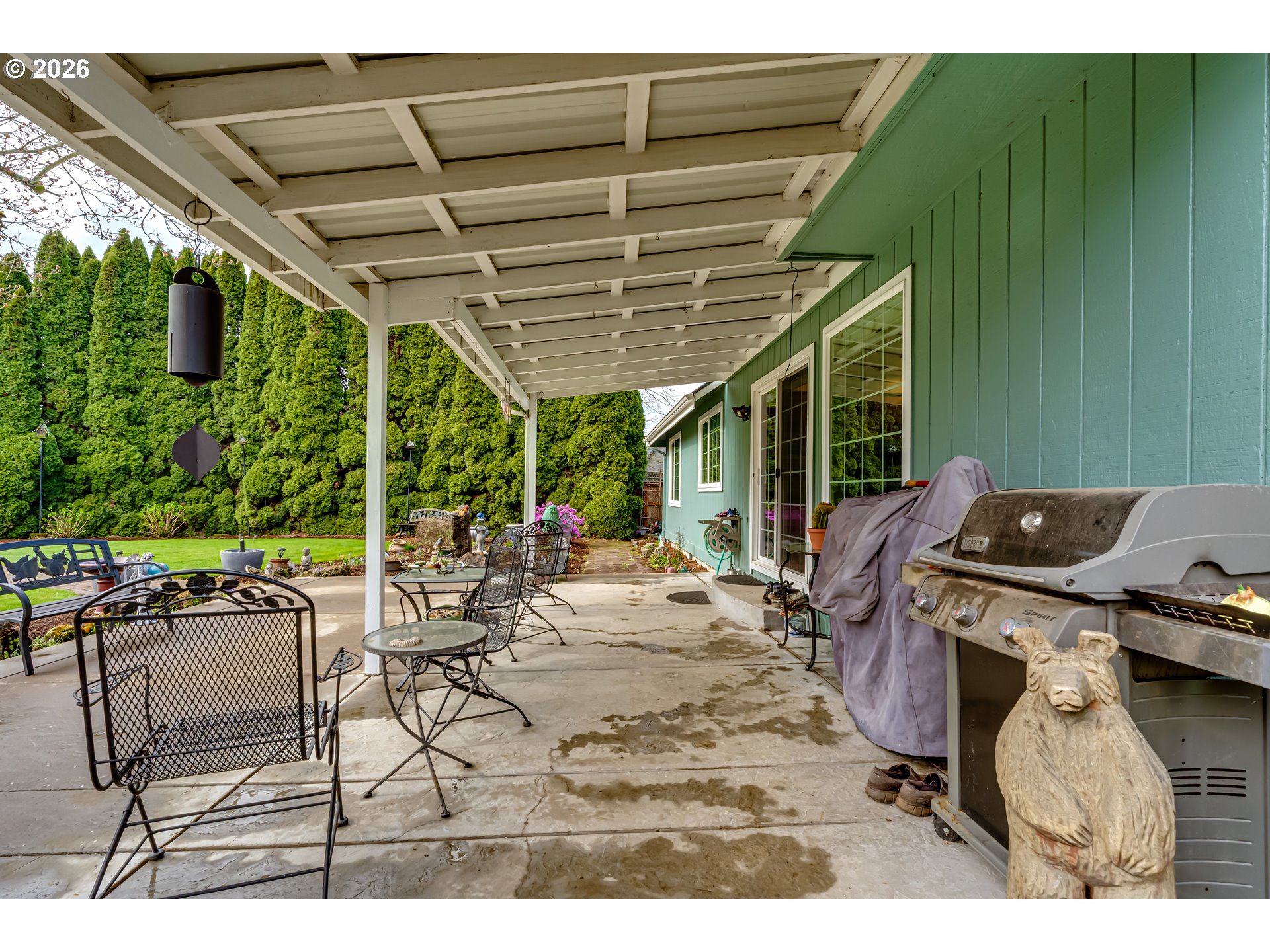 5131 Trevon Street Eugene, OR 97402 - Photo 34 of 42 a view of a patio with table and chairs a barbeque with wooden fence