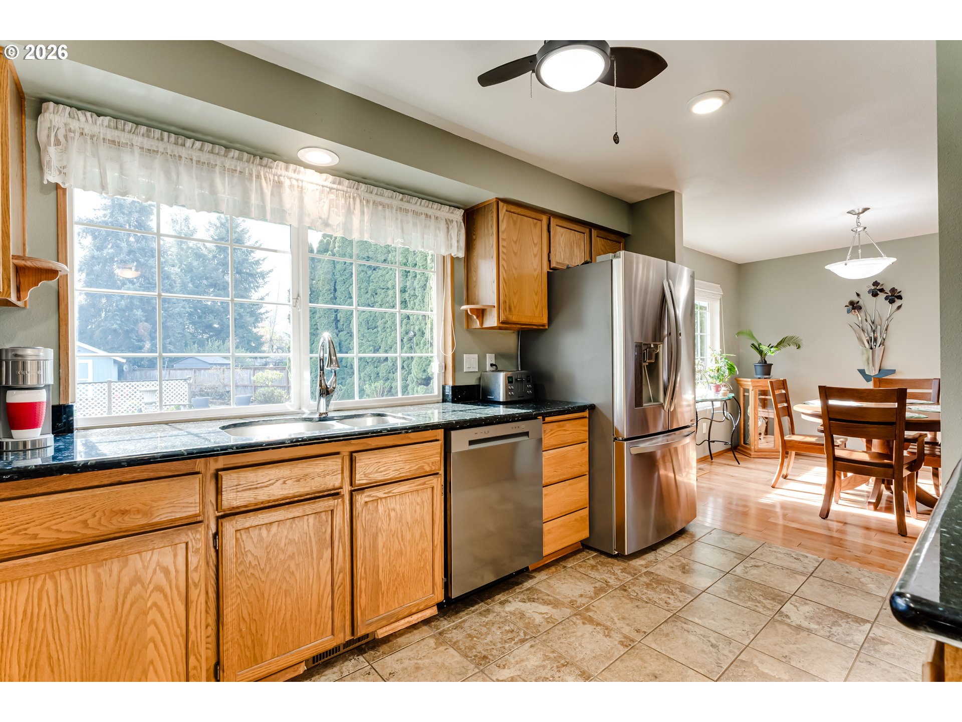 5131 Trevon Street Eugene, OR 97402 - Photo 10 of 42 a kitchen with stainless steel appliances granite countertop a refrigerator a sink a stove and island