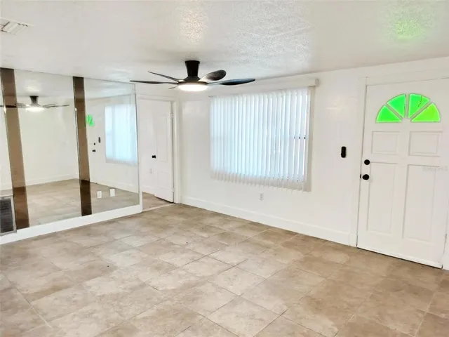 a view of an empty room with a window