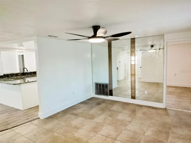 a view of a bathroom with a granite countertop sink mirror and shower