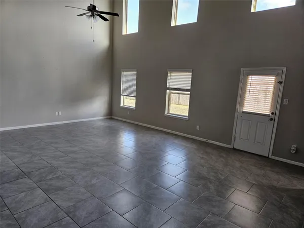 an empty room with windows and closet