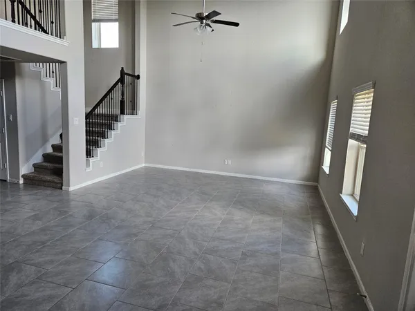 a view of a hallway view with staircase and closet