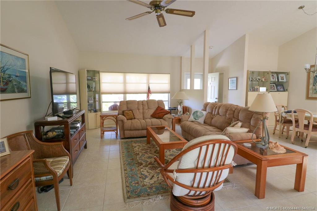 5139 Southeast Hanson Circle Stuart, FL 34997 - Photo 11 of 27 a living room with furniture a fireplace and a window