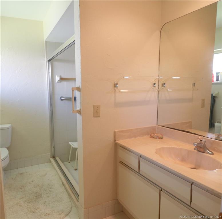 5139 Southeast Hanson Circle Stuart, FL 34997 - Photo 19 of 27 a bathroom with a sink and a mirror