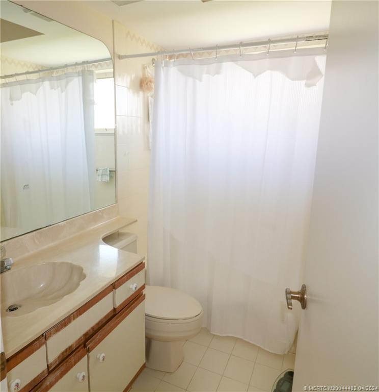 5139 Southeast Hanson Circle Stuart, FL 34997 - Photo 20 of 27 a bathroom with a sink a toilet and shower