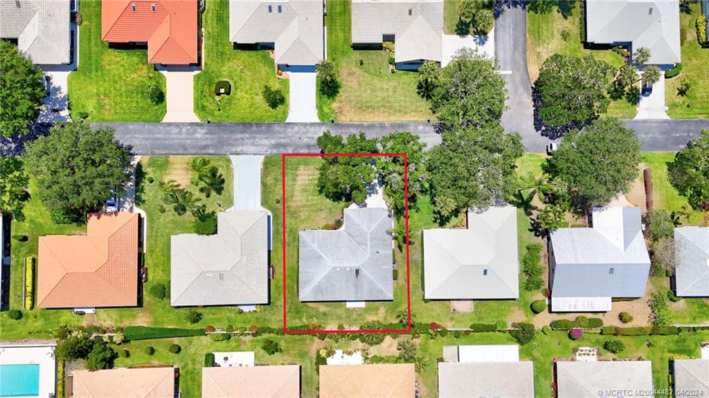 5139 Southeast Hanson Circle Stuart, FL 34997 - Photo 27 of 27 an aerial view of multiple houses with yard