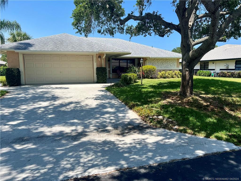 5139 Southeast Hanson Circle Stuart, FL 34997 - Photo 4 of 27 a front view of a house with yard