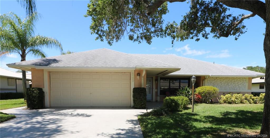 5139 Southeast Hanson Circle Stuart, FL 34997 - Photo 5 of 27 a front view of a house with garden