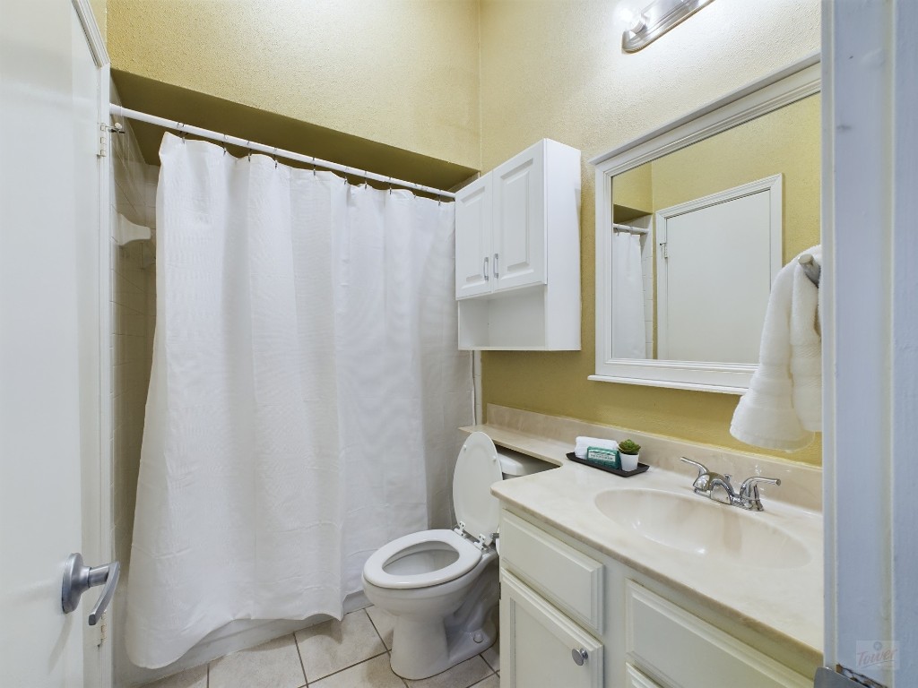 2811 Rio Grande Street, Unit 204 Austin, TX 78705 - Photo 11 of 31 a bathroom with a granite countertop sink toilet and shower