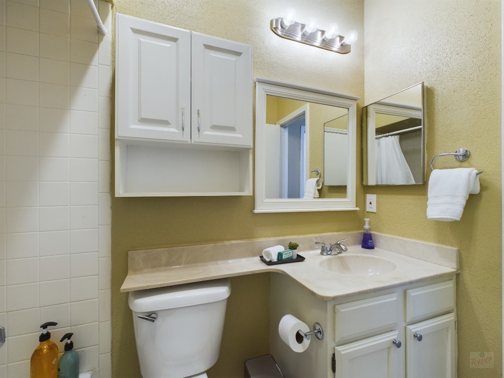 2811 Rio Grande Street, Unit 204 Austin, TX 78705 - Photo 13 of 31 a bathroom with a granite countertop sink and a toilet