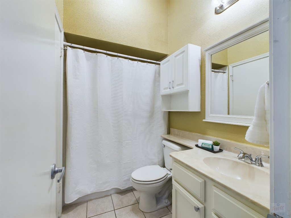 2811 Rio Grande Street, Unit 204 Austin, TX 78705 - Photo 14 of 31 a bathroom with a sink a toilet and shower