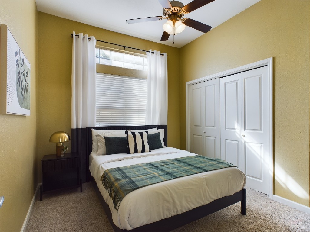 2811 Rio Grande Street, Unit 204 Austin, TX 78705 - Photo 15 of 31 a bedroom with a large bed and a chandelier