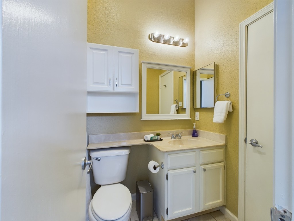 2811 Rio Grande Street, Unit 204 Austin, TX 78705 - Photo 19 of 31 a bathroom with a sink toilet and mirror