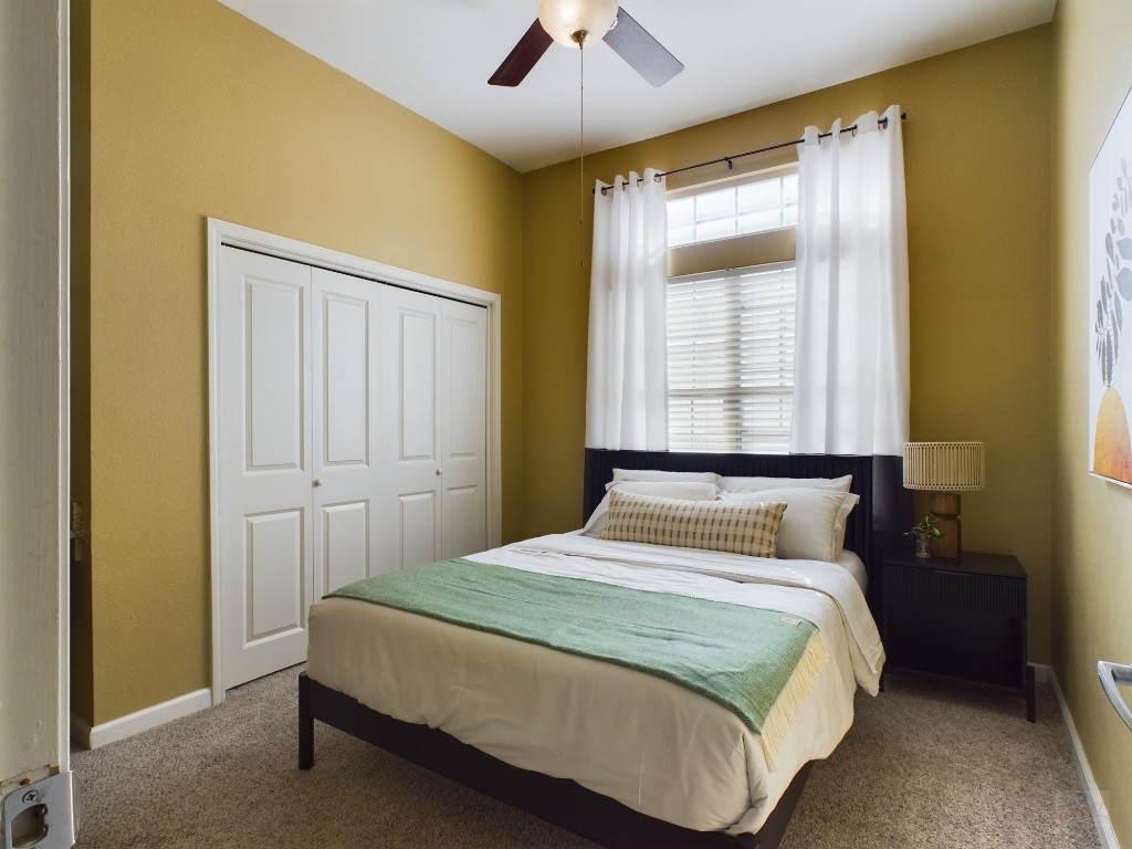 2811 Rio Grande Street, Unit 204 Austin, TX 78705 - Photo 20 of 31 a bedroom with a bed and a chandelier