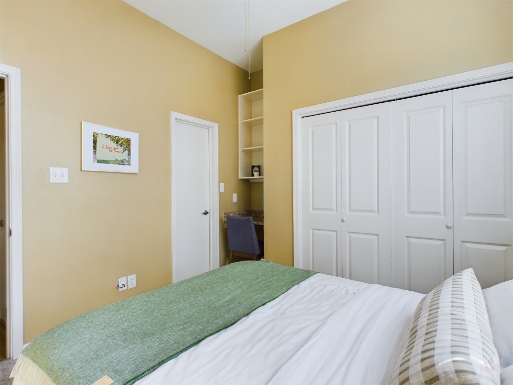 2811 Rio Grande Street, Unit 204 Austin, TX 78705 - Photo 23 of 31 a bedroom with a bed and a painting on the wall