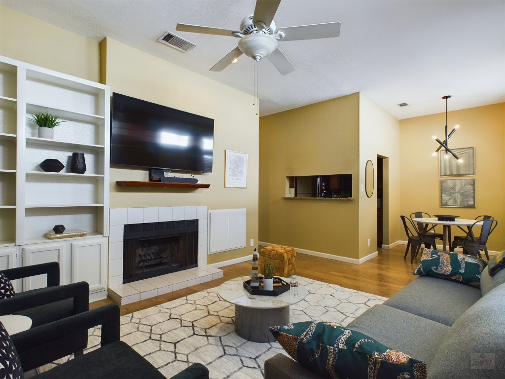 2811 Rio Grande Street, Unit 204 Austin, TX 78705 - Photo 5 of 31 a living room with furniture a flat screen tv and a fireplace