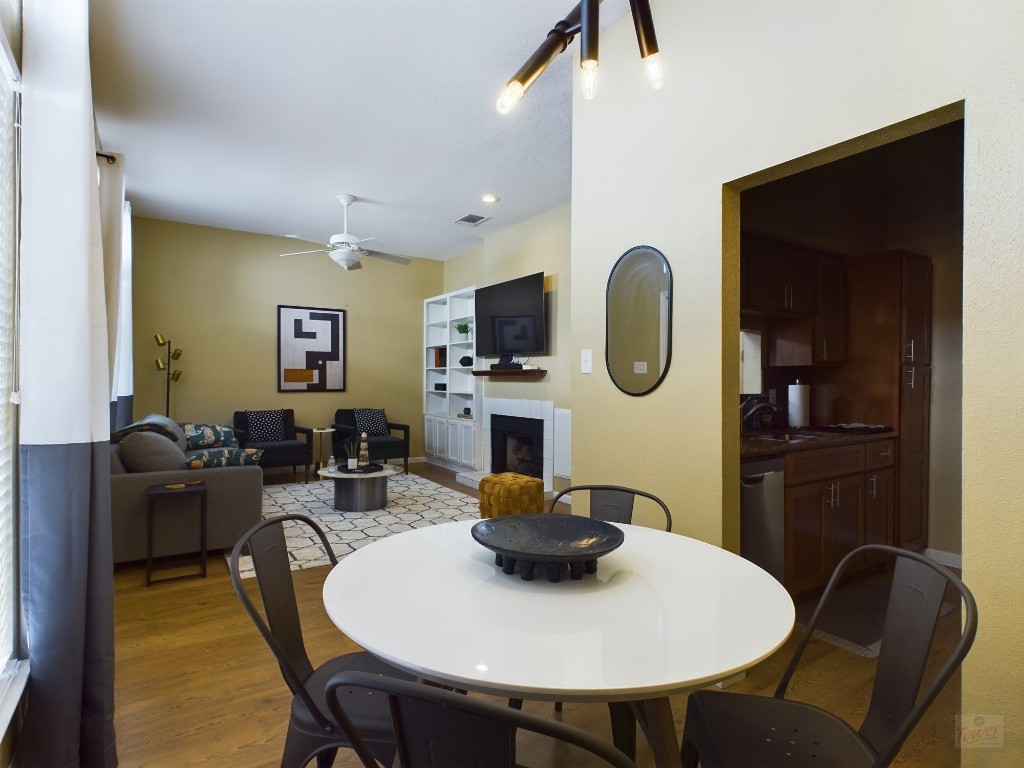 2811 Rio Grande Street, Unit 204 Austin, TX 78705 - Photo 7 of 31 a living room with furniture a flat screen tv and a fireplace