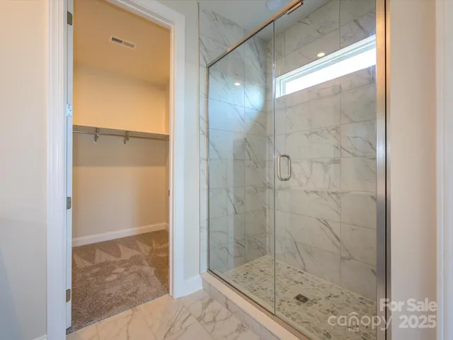 a bathroom with a glass shower door