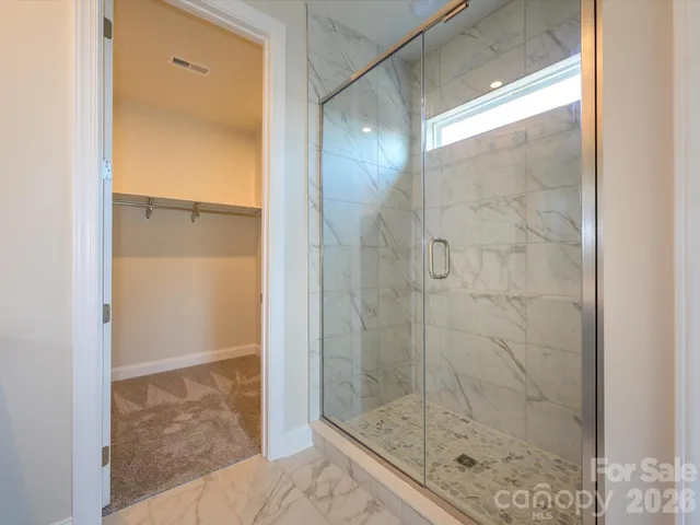 a bathroom with a glass shower door