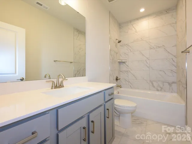 a bathroom with a sink a toilet and bathtub