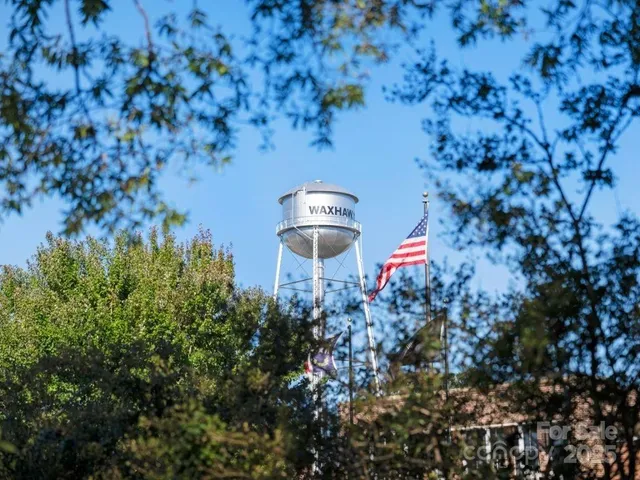 a front view of a house with a yard and trees