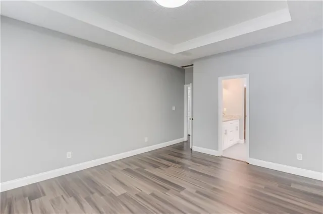 a view of an empty room and wooden floor
