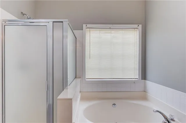 a bathroom with a bathtub and a shower