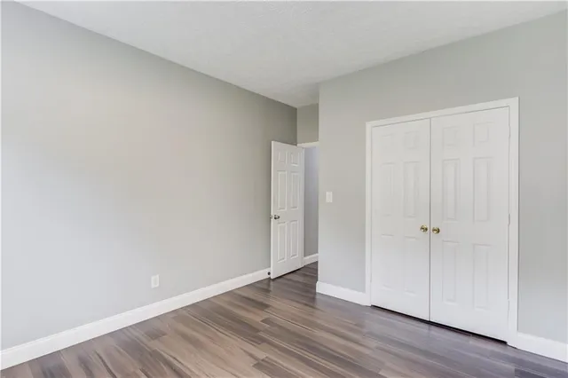a view of an empty room and wooden floor