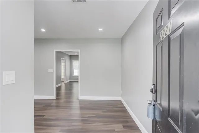 a view of empty room with wooden floor