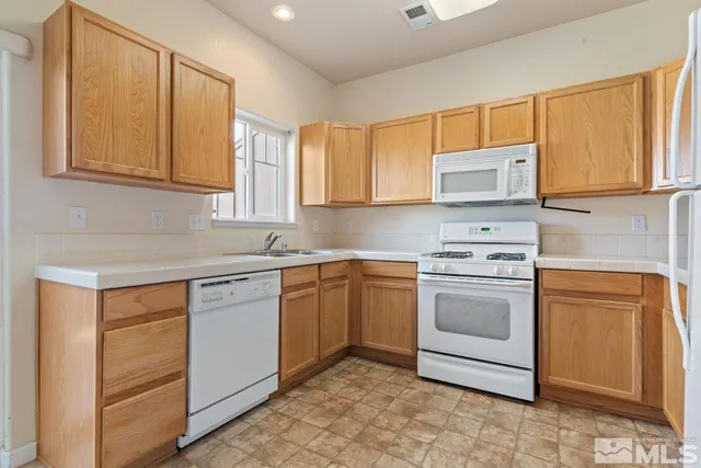 a kitchen with stainless steel appliances granite countertop a sink and cabinets